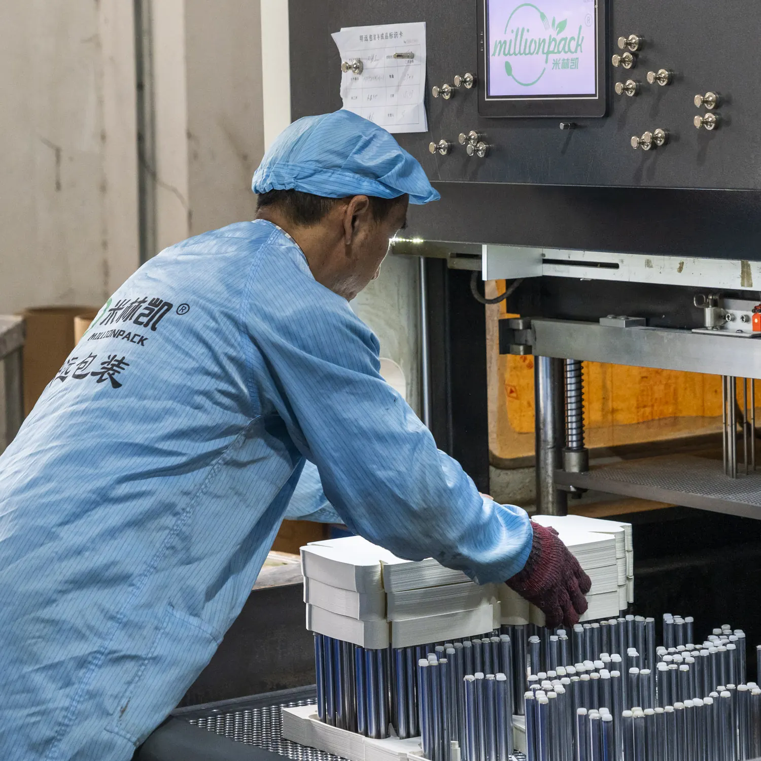 Operator checking formed food packaging